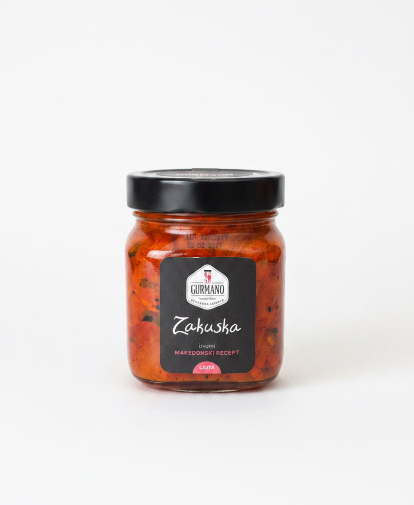Jar of Zakuska with a black lid on a white background