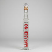 Miniature 0.10 L bottle of original Maraska Maraschino liqueur with vertical red lettering and a classic cork stopper