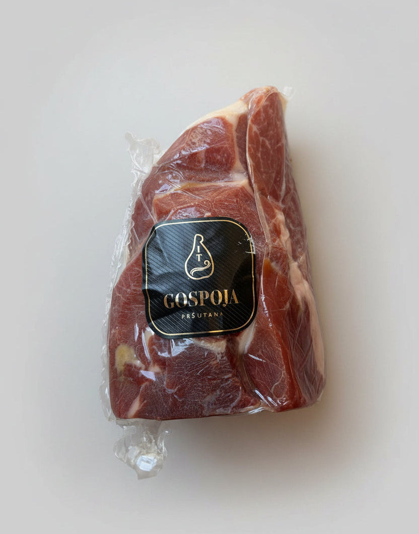 Packaged meat with a Gospoja label on a beige surface