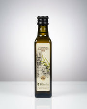 Bottle of olive oil with a label on an orange surface