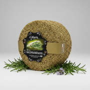 Round cheese wheel with a label on a white background