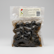 Packaged black olives with a label on a white background