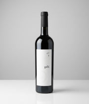 Wine bottle with a white label on a gray background