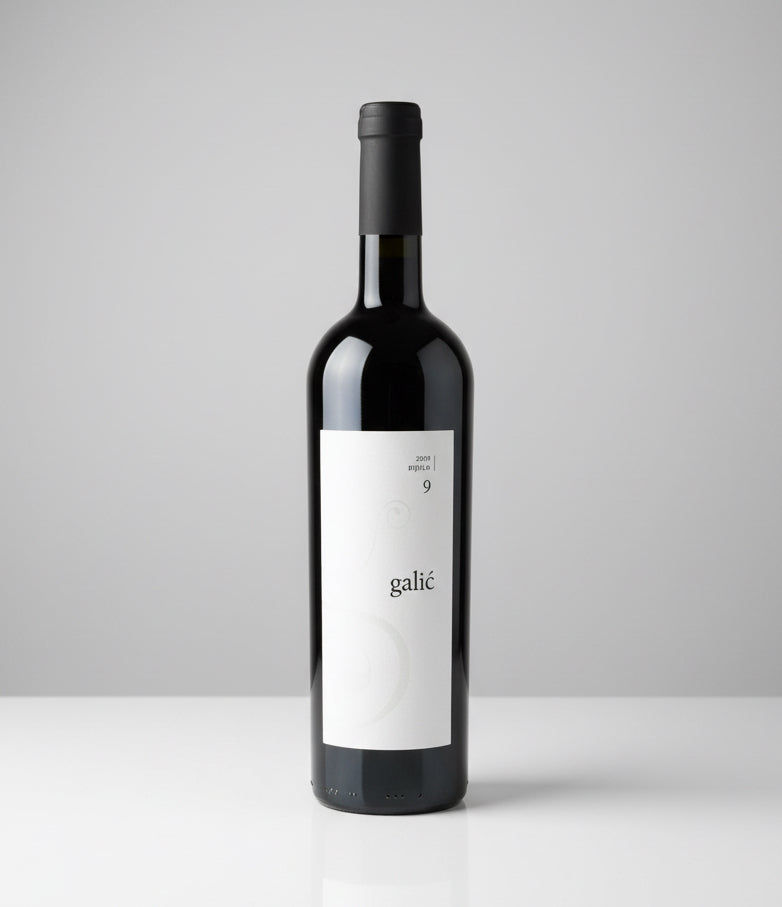 Wine bottle with a white label on a gray background