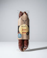 Packaged meat product on a gray surface with visible brand label.