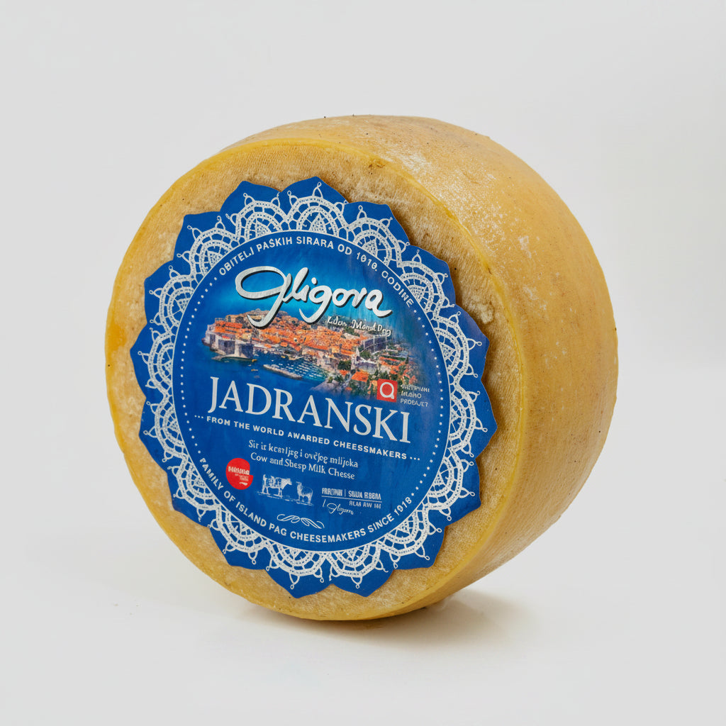 Round cheese wheel with a blue label on a white background