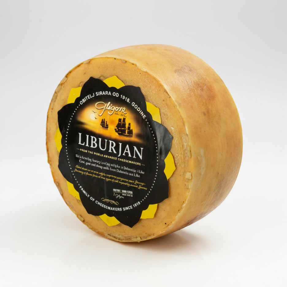 Round cheese wheel with a black and yellow label on a white background