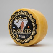 Round yellow cheese wheel with a black label featuring a woman's face and 'Gligora' branding on a white background.