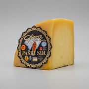Block of cheese with a Gligora label on a white background
