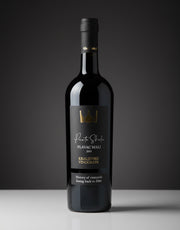 Wine bottle with a dark label on a gray background