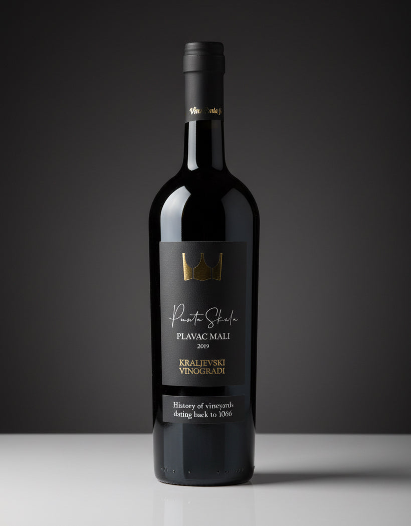 Wine bottle with a dark label on a gray background