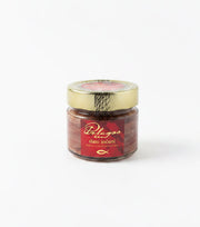 Jar of Pelagos sun dried anchovies on a white background