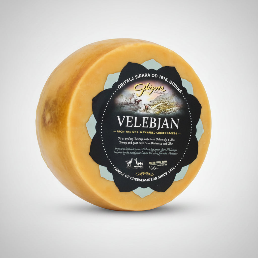 Round cheese wheel with 'Velebjan' label on a white background