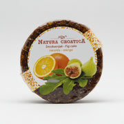 Round cake with orange and fig design on packaging against a white background