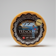 Round cheese with a black label on a white background