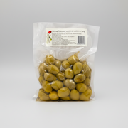 Packaged green plums with a label on a white background