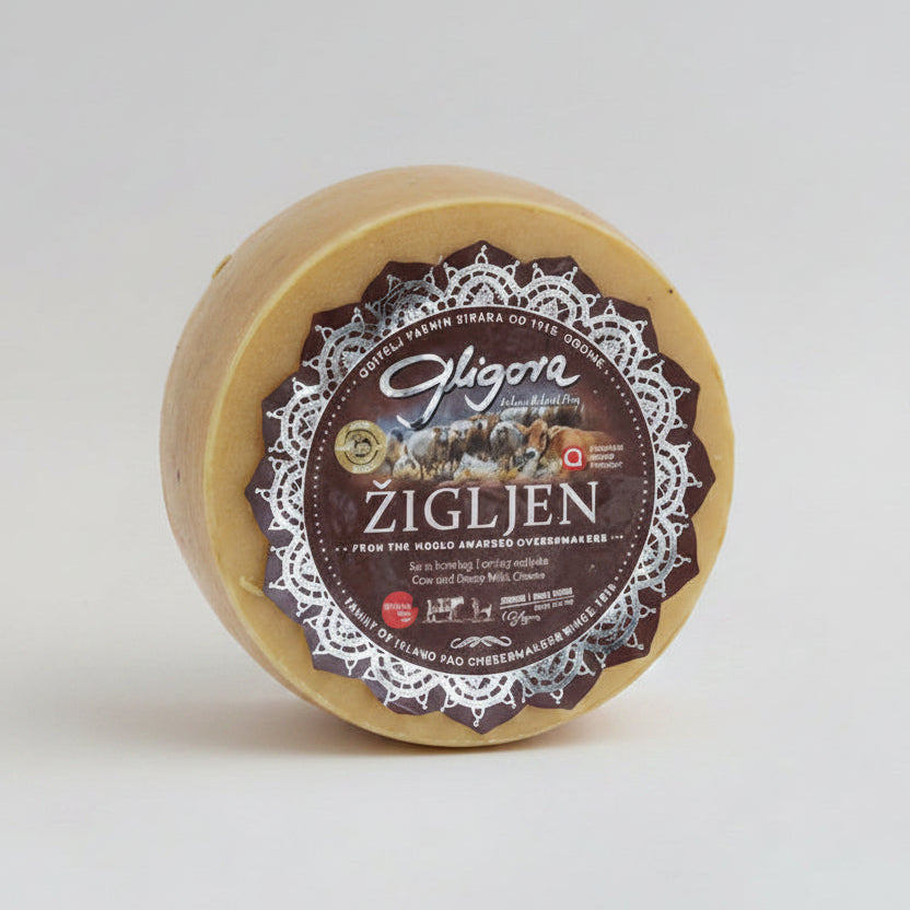 Round cheese with a decorative label on a white background