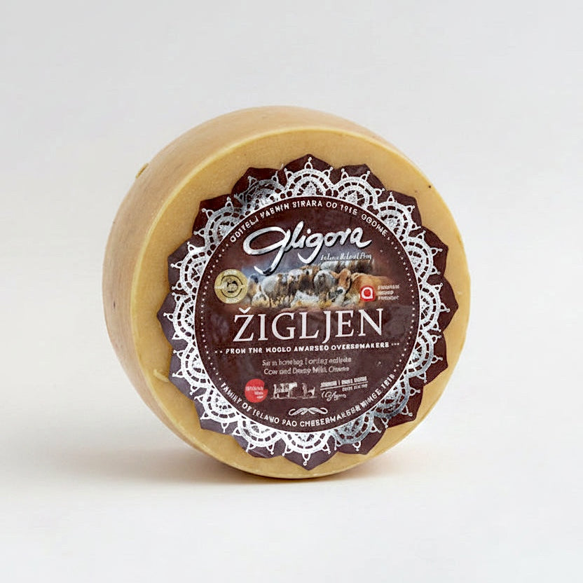 Round cheese wheel with 'Gligora Zigljen' label on a white background