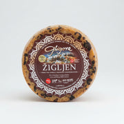 Round cheese with a Gligora label on a white background