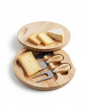 Wooden cheese board set with cheese and tools on a white background