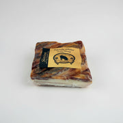 Packaged pork ham with a label on a white background
