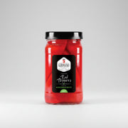 Jar of red peppers with a black lid on a gray background