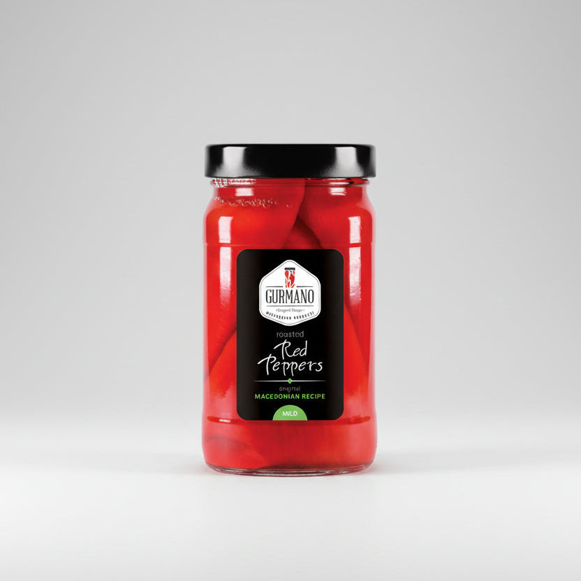 Jar of red peppers with a black lid on a gray background
