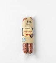Packaged sausage with a visible label on a white background