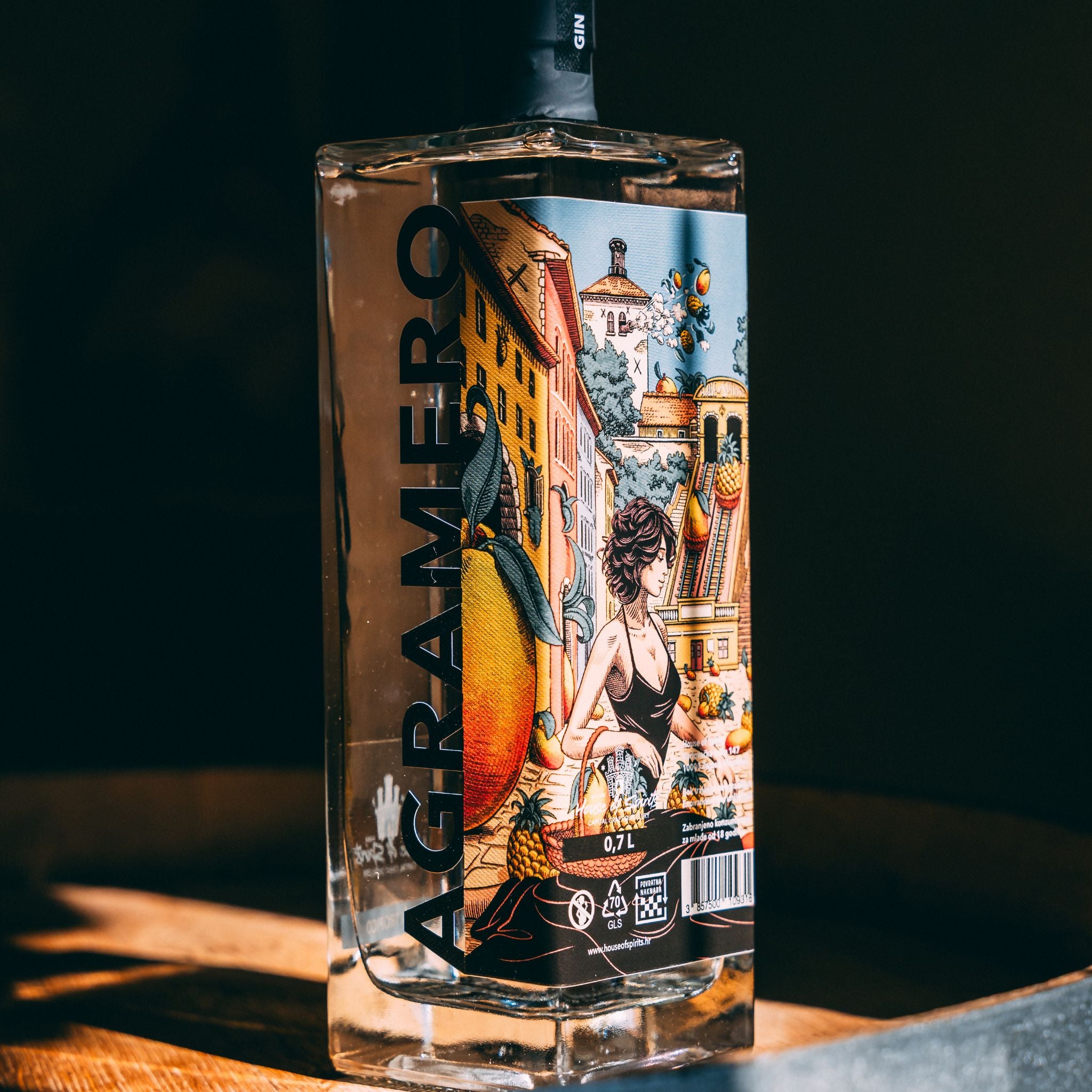 Bottle of Agramoro gin with a colorful label on a dark background