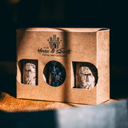 Brown packaging box with 'House of Spirits' branding on a wooden surface.